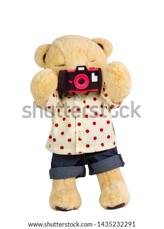 Teddy bear holding camera on white background isolate