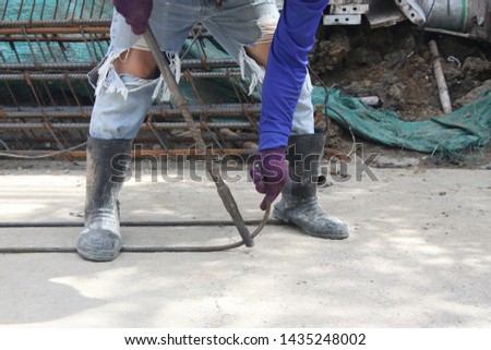 

The builder made wrought iron with a bending machine, a device for bending metal to bend. worker bending iron on construction site
