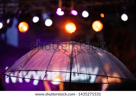 transparent umbrella on the concert light background