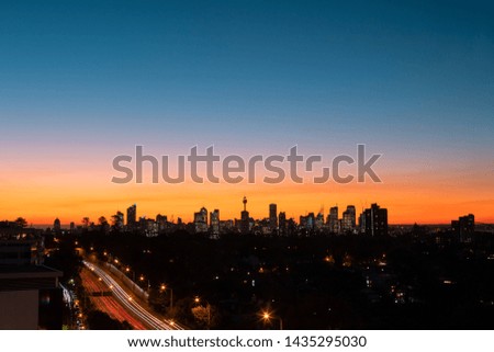 Sydney skyline with orange blue sky at dusk.