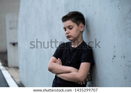 Portrait of a sad teenage boy looking thoughtful about troubles. Pensive teen. Depression, teen depression, pain, suffering