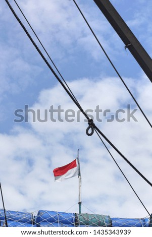 Indonesia flag on the pole with rope as a foreground