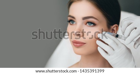 beauty injections into beautiful face. smoothing of mimic wrinkles around the eyes using biorevitalization Royalty-Free Stock Photo #1435391399