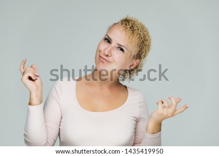 Photo portrait of a beautiful girl blonde woman with short curly hair on a white background talking and showing a lot of emotions. An experienced model shows hands. Beauty. Made in studio