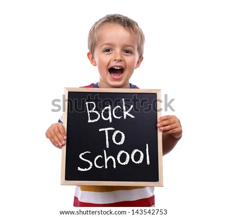 Young child holding back to school chalk blackboard sign standing against white background