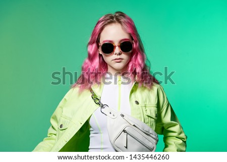 woman with pink hair with glasses portrait