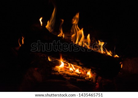 campfire with smoke and flame at night