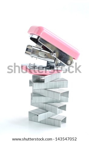 Pink stapler with staples stack, on white background