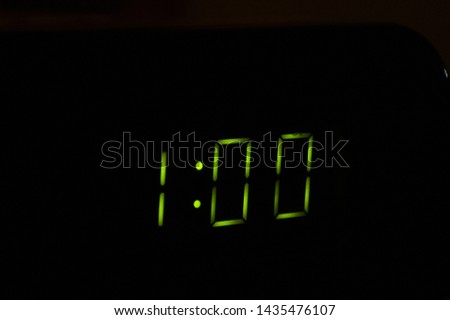 digital microwave display clock showing the time 01:00 in green color