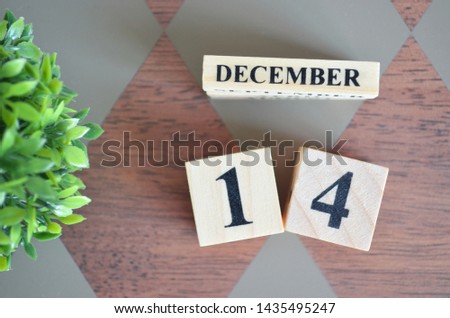 Date of December month with leaf on diamond pattern table for background.