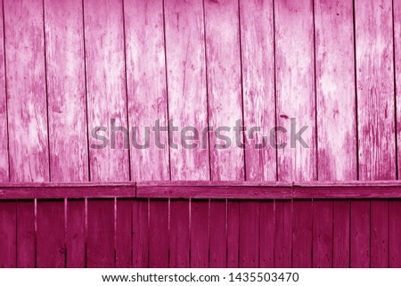 Old grunge wooden fence and wooden wall pattern in pink tone. Abstract background and texture for design.