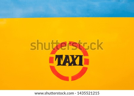 TAXI written on yellow taxi in kolkata city, India