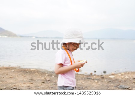 YOUNG KID CHECKING PHOTO ON CAMERA