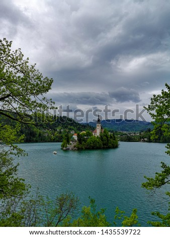 Lake Bled with St. Marys Church of Assumption on small island in the middle of the lake. Bled, Slovenia, Europe. Mountains and valley on background. European nature and culture
