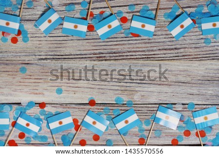 July 9. Independence day of Argentina, the concept of the Day of memory, freedom and patriotism. Mini flags with paper confetti on wooden white background. copy space