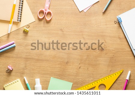 Flat lay school stationery on a wooden background. Back to school concept, creative layout. Top view, overhead.  Royalty-Free Stock Photo #1435611011