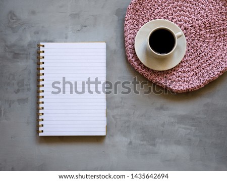 Cup of coffee on gray table in minimal style, Top view. Business team work meeting concept