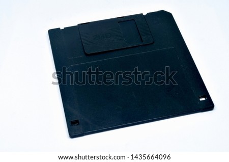 The old black floppy disk is an electronic storage device For computers.
