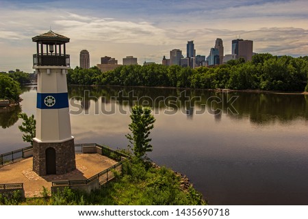 Minneapolis skyline reflected in the Mississippi river, lighthouse in foreground