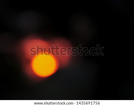 Orange bokeh on black background. Abstract blurred background