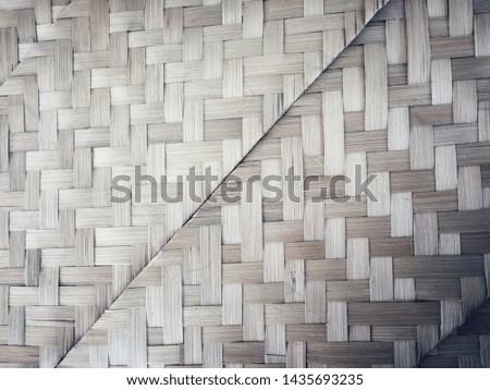 The bamboo's woven dark texture and tilting position.