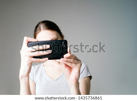 Portrait of beautiful young woman take a photo with mobile phone