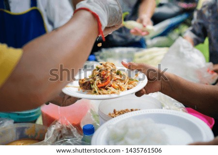 Social concept of poor people sharing : Concept serving free food to the poor : Free food, Using leftovers to feed the hungry : Food concept of hope : The poor are reaching for food
