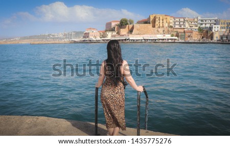 A picture of a girl in Crete Island, Chania, showing that holiday feeling of relaxation while looking at the sea.