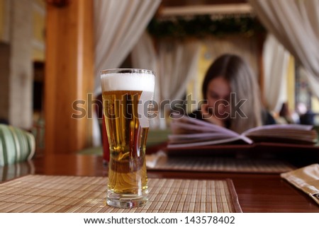 Glass of draught beer on a table in the restaurant