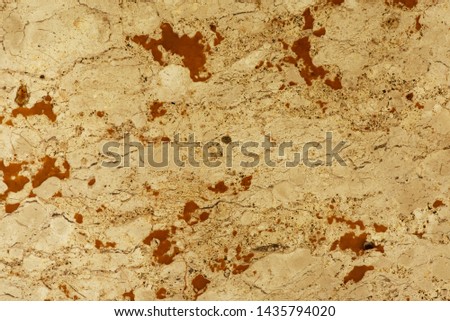 Golden marble texture of a natural white and golden stone tile.