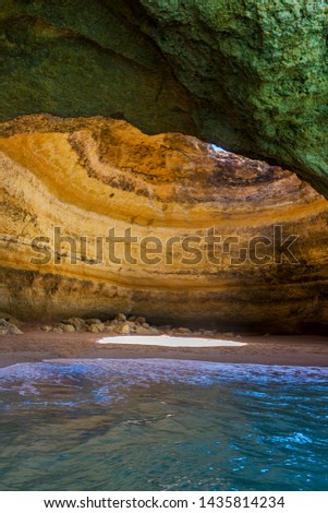 inside a cave with a hole in the ceiling where the sea reaches its interior