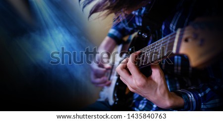 Electric guitar playing. Young men playing electric guitar. Closeup Photography.