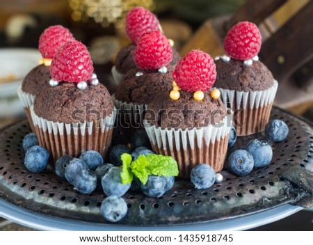 Cupcakes/brownies with various fruits on top blueberries, strawberries, rasberries