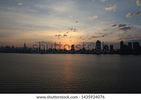 Sunrise on Manhattan skyline with reflection