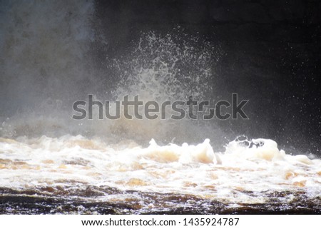 Crashing water at the base of a waterfall