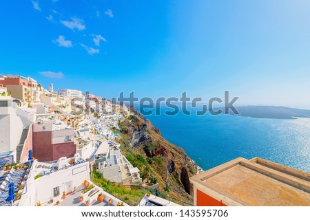Greece famous Santorini island in Cyclades, panoramic view of traditional whitewashed and colorful houses with caldera sea in background
