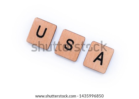 The abbreviation USA - standing for the United States of America, spelt with wooden letter tiles over a white background. 