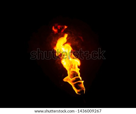 flame of a torch in the dark on a black background, only the fire is visible Royalty-Free Stock Photo #1436009267