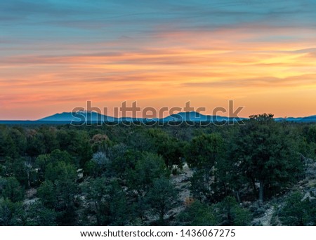 Mt Humphreys visible at sunset behind Kaibab National Forest.  Royalty-Free Stock Photo #1436067275