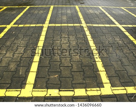  yellow lines in weathered asphalt parking lot