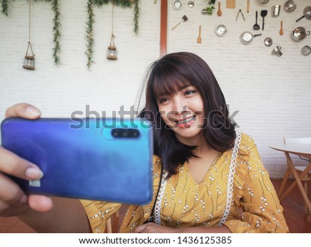 Close up Asia woman taking selfie with her smart phone.