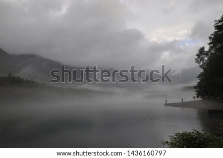 Taisho Lake in Kamikochi at the foggy rainy misty day early in the morning