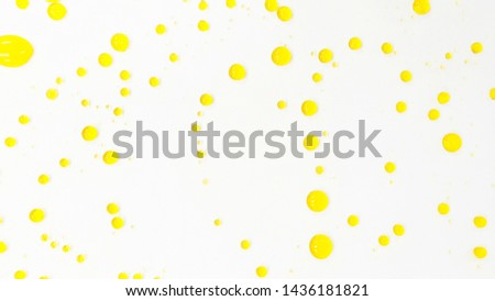 Beautiful yellow water droplets on the white background 