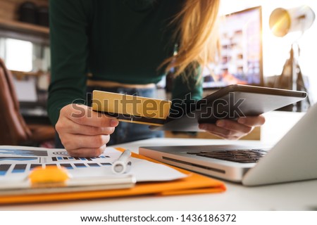 Business woman hands using smartphone and holding credit card with digital layer effect diagram as Online shopping concept

