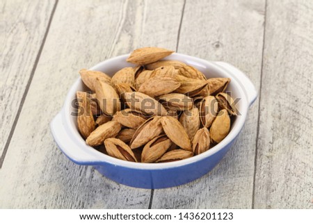 Unpeeled Almonds nuts heap in the bowl