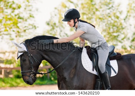 riding young woman portrait on horse in outdoor Royalty-Free Stock Photo #143620210