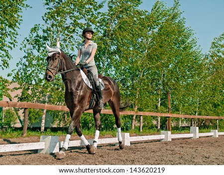 riding young woman on horse in outdoor Royalty-Free Stock Photo #143620219