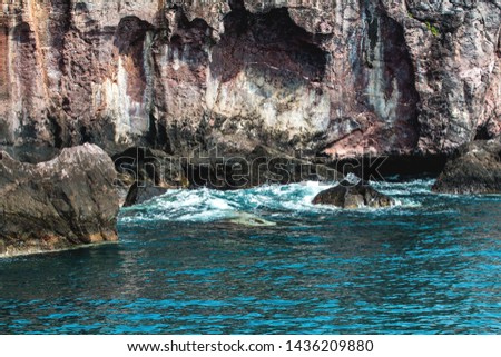 island,Rocky cliff with blur view of trees grown on the surface, of a the tropical island under blue sky , Bang Saphan Noi Prachuap Khiri Khan, Thailand
 Royalty-Free Stock Photo #1436209880