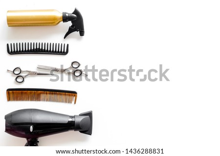 Combs, dryer and hairdresser tools in beauty salon work desk on white background top view mockup