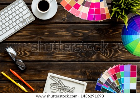 Work space of designer with instruments, pallet, keyboard, glasses and coffee wooden background top view space for text